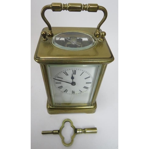 180 - An early 20th century brass cased carriage clock, with key, 11cm high to top of case. Together with ... 