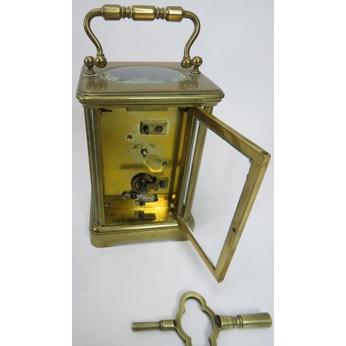 180 - An early 20th century brass cased carriage clock, with key, 11cm high to top of case. Together with ... 