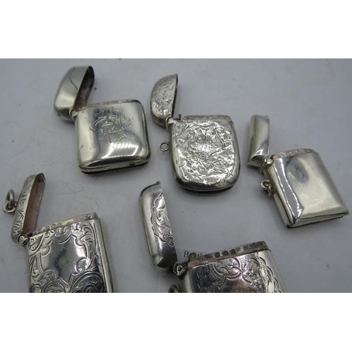 405 - A collection of five silver vesta cases. Three with foliate engraved design, one with monogram and o... 