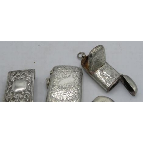 405 - A collection of five silver vesta cases. Three with foliate engraved design, one with monogram and o... 