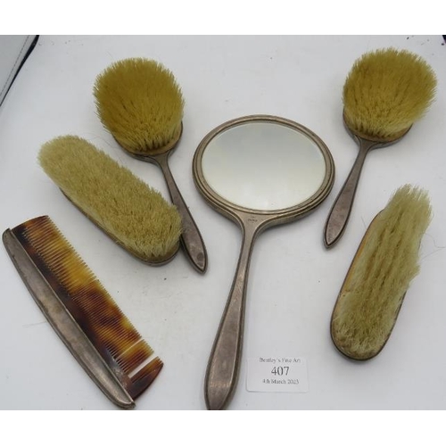 407 - A six piece Art Deco silver dressing table set comprising of mirror, two hair brushes comb and two c... 