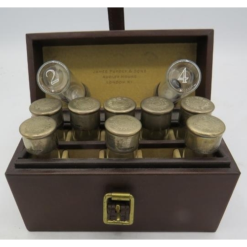 410 - A unusual travelling case of 10 individually numbered small glass bottles with silver tops marked Pu... 