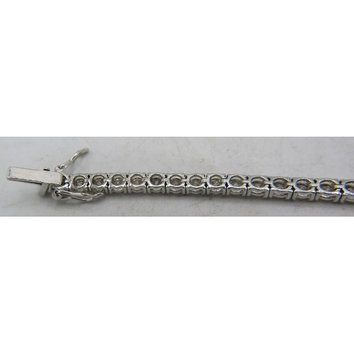 424 - An 18ct white gold round brilliant cut line bracelet. Diamonds 7.01cts, approx weight 12.8 grams, bo... 