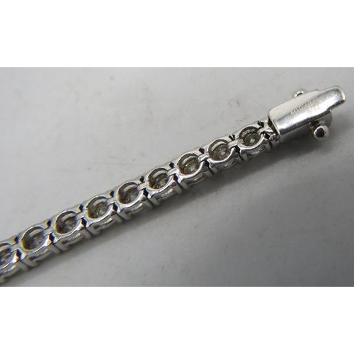 424 - An 18ct white gold round brilliant cut line bracelet. Diamonds 7.01cts, approx weight 12.8 grams, bo... 