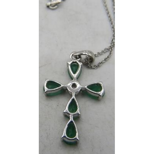 425 - A 9ct white gold pear shaped emerald & single diamond cross pendant with a silver chain. Emeralds ap... 