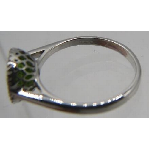 426 - An 18ct white gold cushion shaped checkerboard peridot & diamond halo ring. Peridot 1.30ct, diamonds... 