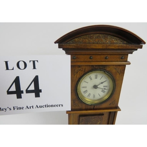 44 - Miniature long case clock, walnut, traces of gilding to etched panel, not tested, 18cm height. 
Cond... 