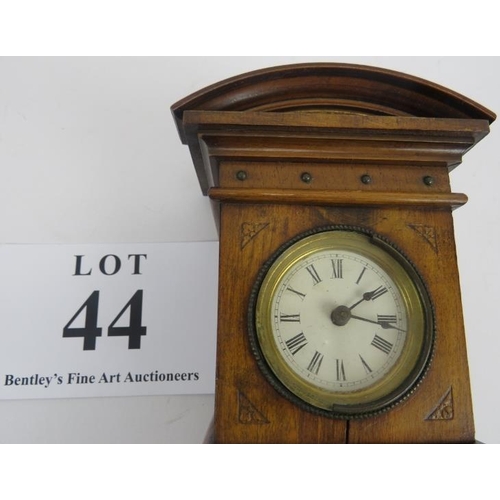 44 - Miniature long case clock, walnut, traces of gilding to etched panel, not tested, 18cm height. 
Cond... 