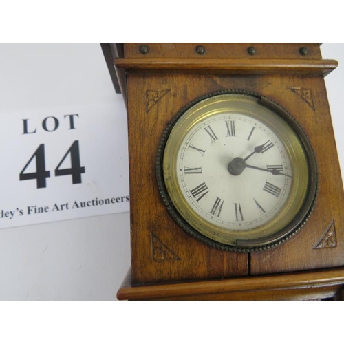 44 - Miniature long case clock, walnut, traces of gilding to etched panel, not tested, 18cm height. 
Cond... 