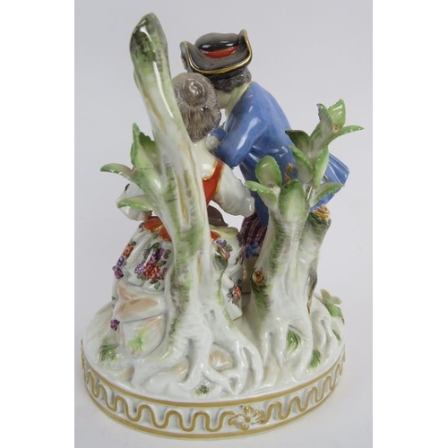 68 - A porcelain Meissen figurine of a courting couple in 18th Century costume. Hand decorated with cross... 