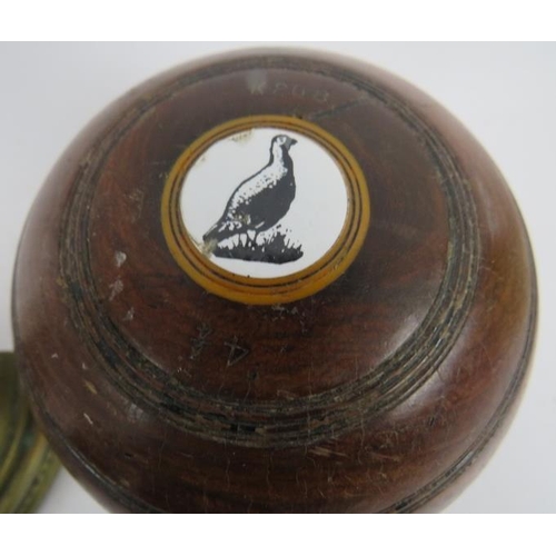 79 - Two vintage Lignum Vitae presentation lawn bowls, a vintage wooden money box and key, a brass lead f... 