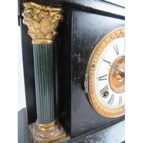 82 - An antique American striking mantel clock with blackened steel case and Ansonia movement. Key and pe... 