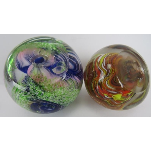 87 - Two multicoloured glass paperweights one with green and blue scroll form and etched mark to base. (2... 