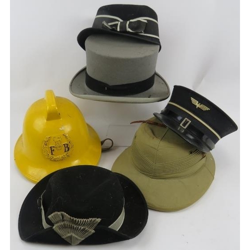 96 - A 1970s Fireman's helmet, two vintage St John's Ambulance hats, a Swiss railways hat, grey top hat a... 