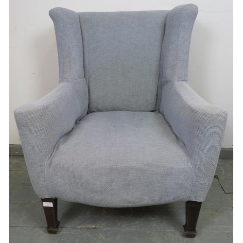 877 - A Georgian wingback armchair of small proportions, reupholstered in orange material with a grey loos... 