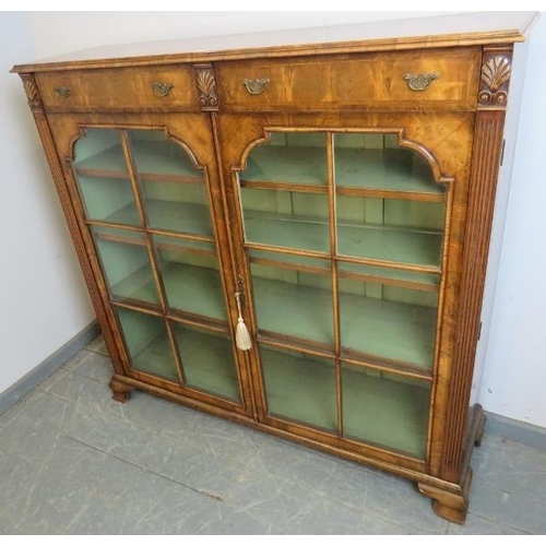 702 - A good quality Georgian Revival low glazed bookcase, with crossbanded inlay and shell carved capital... 