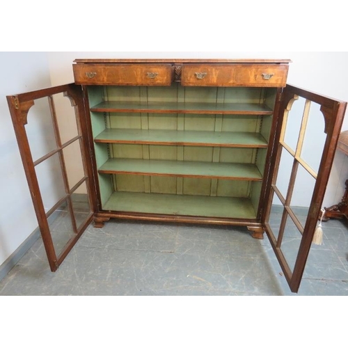 702 - A good quality Georgian Revival low glazed bookcase, with crossbanded inlay and shell carved capital... 