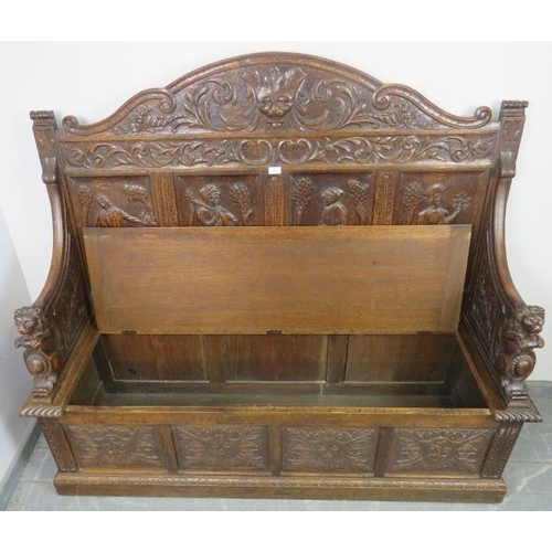 708 - A 19th century high-back oak box settle, the very ornate relief carving depicting a central lion mas... 