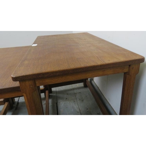 718 - A vintage medium oak Mouseman set of three graduated nesting tables by Robert Thompson, on chamfered... 