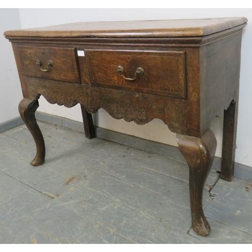 723 - An early 18th century oak sideboard strung with satinwood and ebony, housing two short drawers with ... 