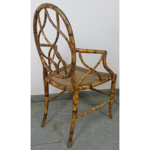 728 - A Regency Period bamboo elbow chair, with shaped and pierced back and sides, retaining the original ... 