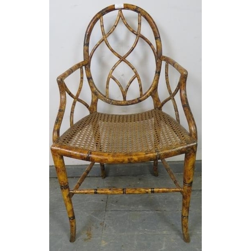 728 - A Regency Period bamboo elbow chair, with shaped and pierced back and sides, retaining the original ... 