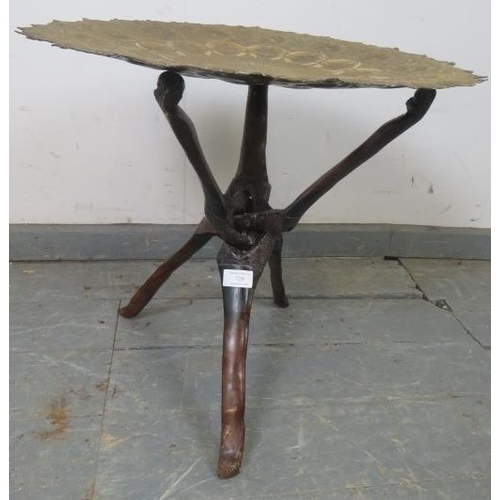 729 - An antique North African folding tray table, the dished brass top featuring intricately hand-tooled ... 