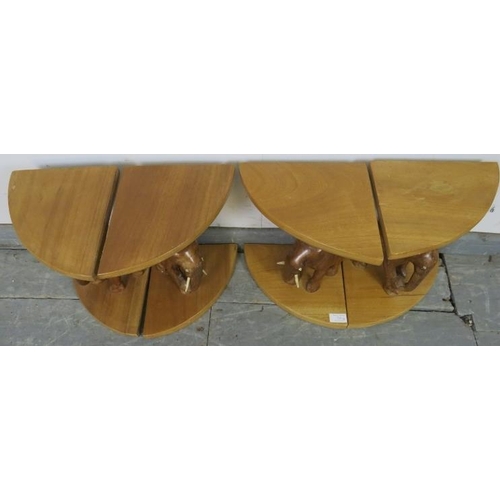 739 - Four vintage teak nesting tables with carved bases in the form of elephants. 
H33cm W22cm D23cm (app... 