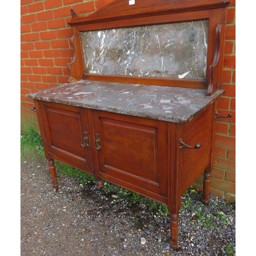 741 - A turn of the century mahogany washstand with marble top and splashback and cupboard under, on turne... 