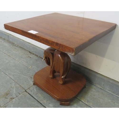 742 - A vintage teak square table with carved stand in the form of an elephant, on a plinth base with bloc... 