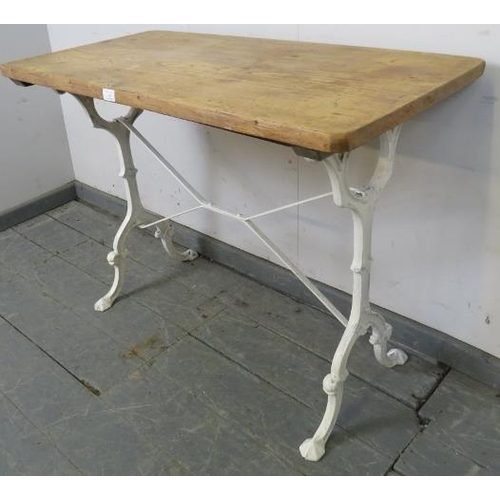 743 - An antique rectangular side table with French light oak top on 19th century cast iron scrolled suppo... 