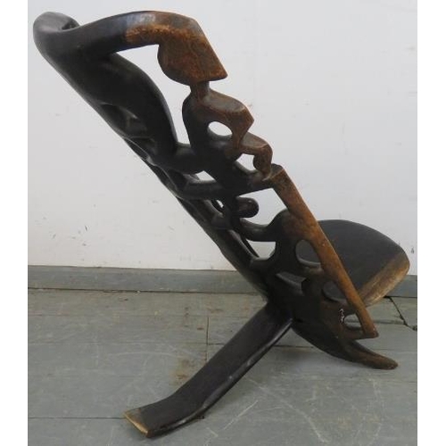 744 - A vintage lignum vitae African birthing stool, with carved and pierced backrest. 
H76cm W38cm D75cm ... 