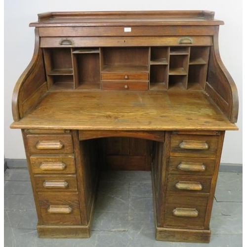 746 - An Edwardian oak ‘S-type’ roll top desk, with ¾ gallery, the fitted interior housing an array of pig... 