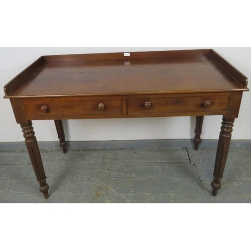 747 - A Victorian mahogany writing table, with 3/4 gallery, housing two short drawers with turned wooden k... 