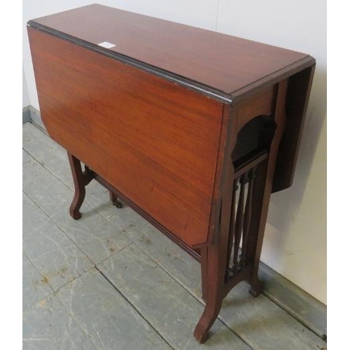 748 - An Edwardian mahogany Sutherland table, with turned spindles to either side, on scrolled supports.
H... 