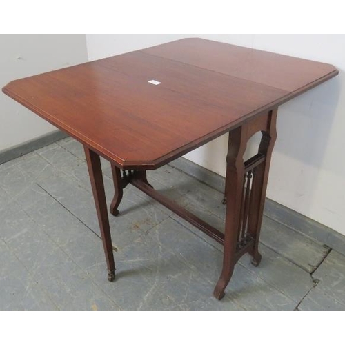 748 - An Edwardian mahogany Sutherland table, with turned spindles to either side, on scrolled supports.
H... 