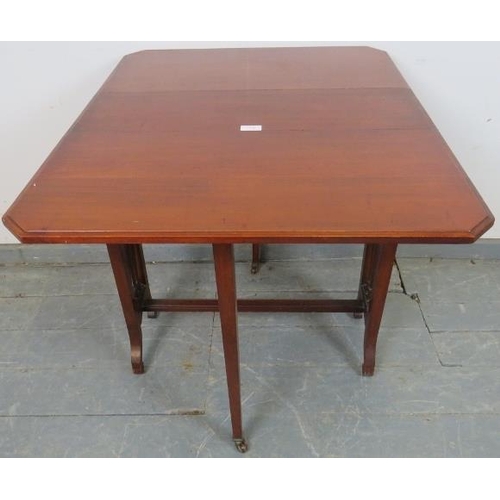 748 - An Edwardian mahogany Sutherland table, with turned spindles to either side, on scrolled supports.
H... 