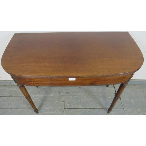 749 - A George III mahogany turnover card table, with reeded edge, on tapering turned supports. 
H71cm W91... 