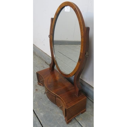 750 - An Edwardian Regency Revival mahogany oval swing mirror, strung with satinwood, above a serpentine b... 