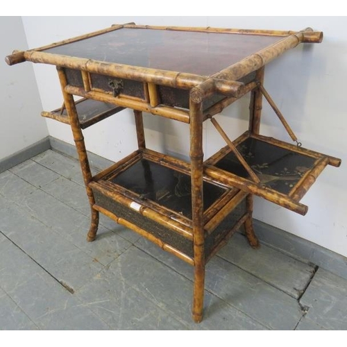 757 - A 19th century colonial bamboo two-tier occasional table, featuring black lacquer panels hand painte... 