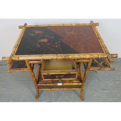 757 - A 19th century colonial bamboo two-tier occasional table, featuring black lacquer panels hand painte... 