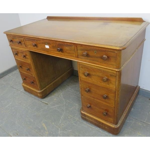 758 - A Victorian mahogany pedestal desk, housing nine graduated drawers with turned wooden knob handles, ... 