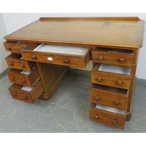 758 - A Victorian mahogany pedestal desk, housing nine graduated drawers with turned wooden knob handles, ... 