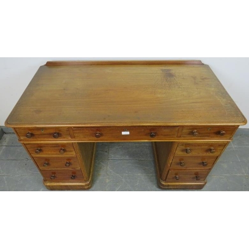 758 - A Victorian mahogany pedestal desk, housing nine graduated drawers with turned wooden knob handles, ... 