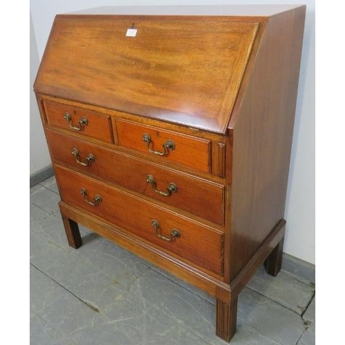 759 - A mid-century teak bureau by Gordon Russell, the cross-banded fall front opening onto filled shelves... 