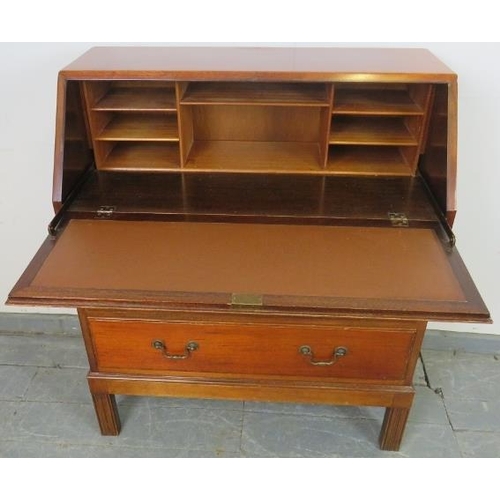 759 - A mid-century teak bureau by Gordon Russell, the cross-banded fall front opening onto filled shelves... 