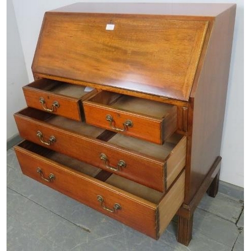 759 - A mid-century teak bureau by Gordon Russell, the cross-banded fall front opening onto filled shelves... 