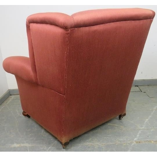 763 - An Edwardian wingback club armchair, re-upholstered in light burgundy material with silver braided r... 