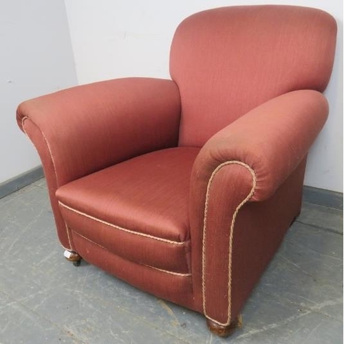 764 - An Edwardian club armchair, re-upholstered in light burgundy material with silver braided rope trim,... 