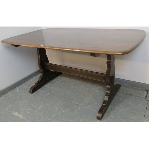 769 - A mid-century elm refectory dining table by Ercol, on shaped supports with a middle stretcher. 
H72c... 